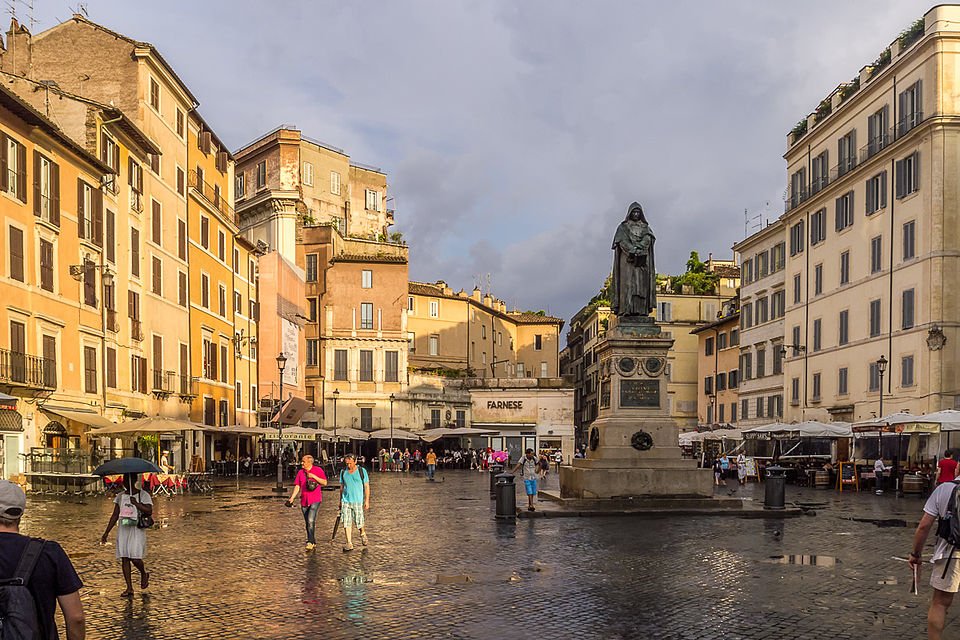 Campo de' Fiori in Rome by day, a bustling market on the site of Giordano Bruno's 1600 execution