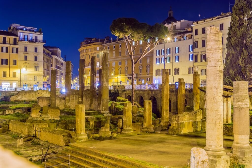 Ancient temple ruins at Largo di Torre Argentina in Rome, lit at night