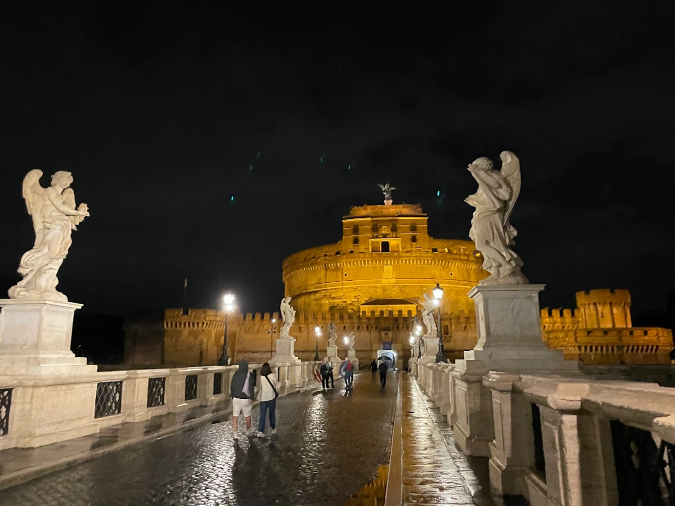 Castel Sant Angelo illuminated at night on the banks of the Tiber during a Rome ghost tour