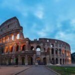 Castel Sant'Angelo and the Bridge of Angels reflected in the Tiber River at night — dark history of Rome