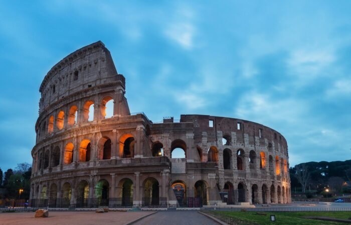 Castel Sant'Angelo and the Bridge of Angels reflected in the Tiber River at night — dark history of Rome